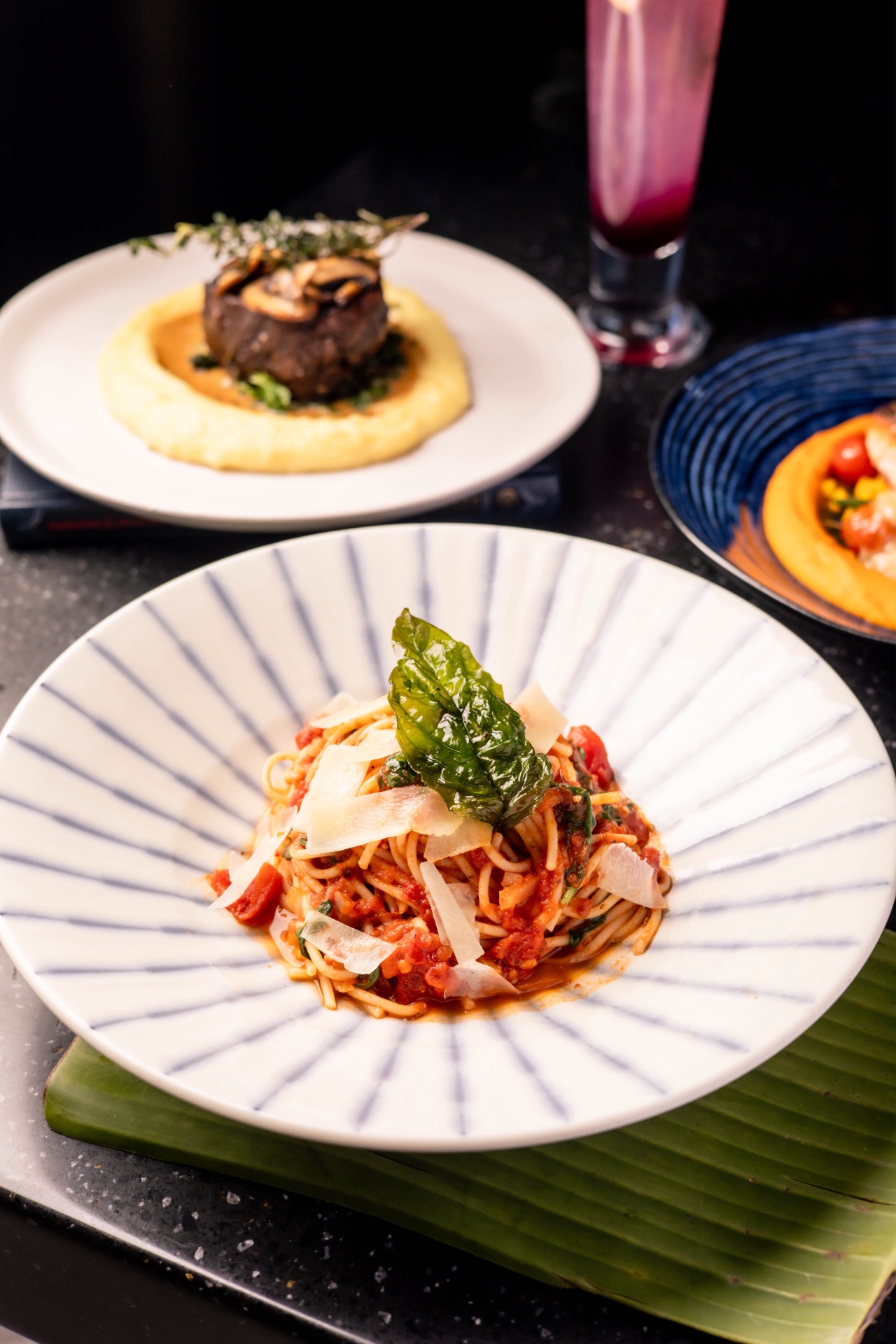 A table of signature dishes and cocktails at Aruna